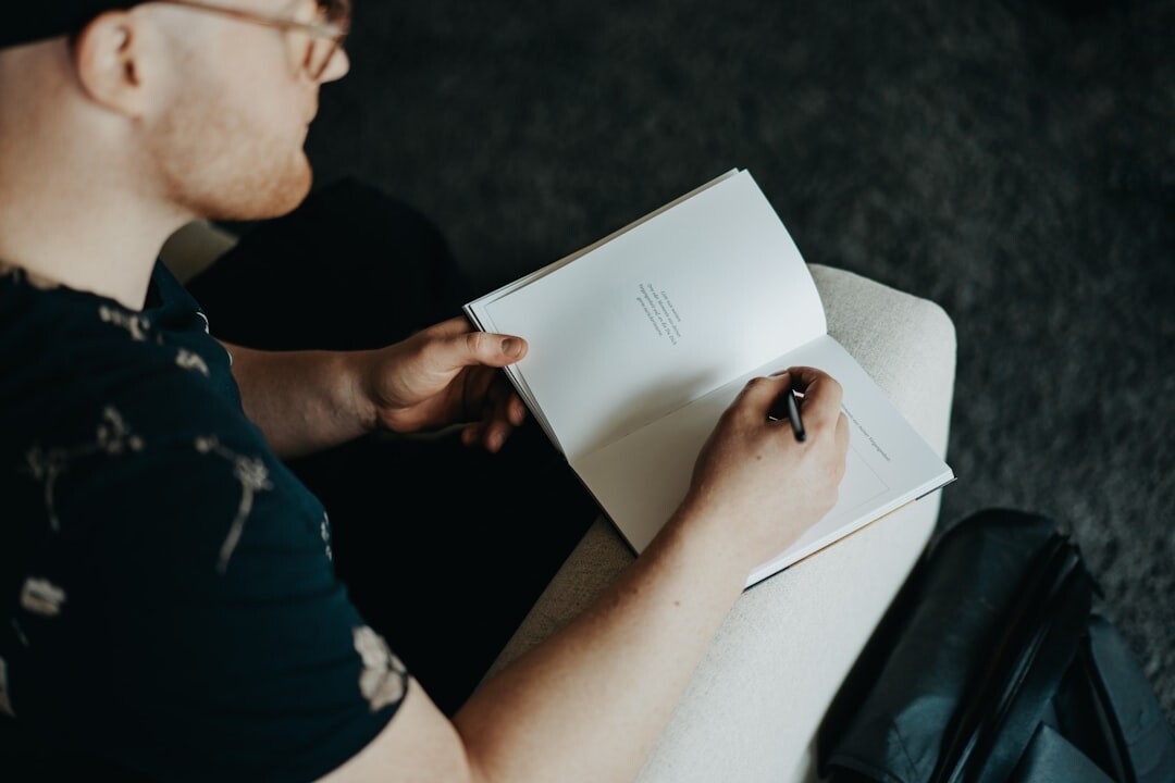 person writing in journal